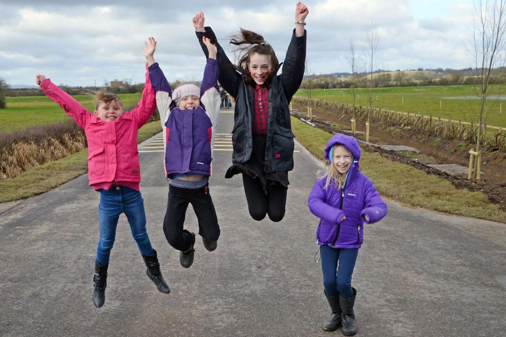 Local children jump for joy at official opening of Muchelney raised road.