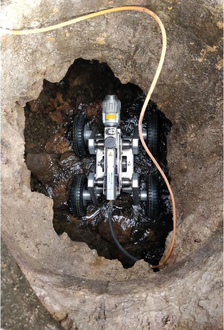 A four-wheeled CCTV device inside a drain.